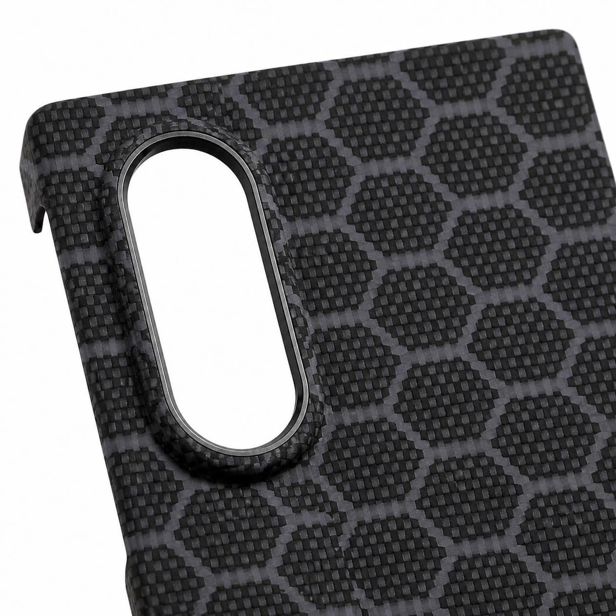 Camera detail: raised surround with a metal ring around the lenses, gray blue honeycomb pattern